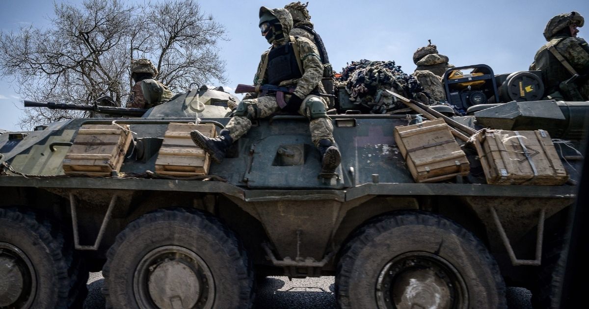 Ukrainian servicemen ride on an armored personnel carrier along a highway on the outskirts of Kryvyi Rih on Thursday.