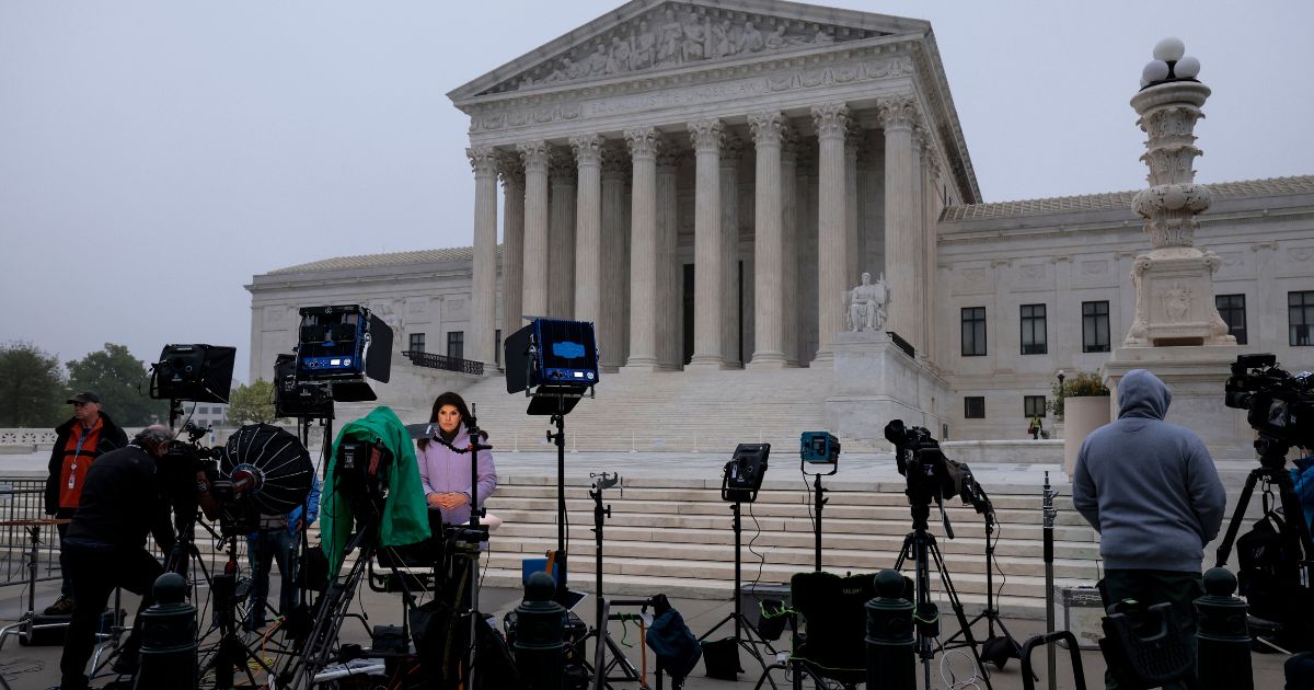 TV camera crews set up outside the Supreme Court building in Washingon on Monday after a report published what was described as a draft opinion by the court majority overturning Roe v. Wade, the 1973 decision that legalized abortion across the United States.