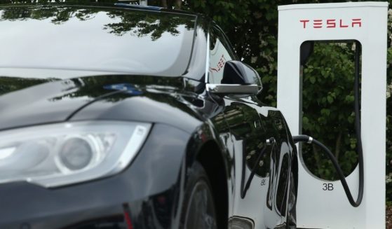 A Tesla electric-powered sedan is pictured at a charging station in Germany in 2015.