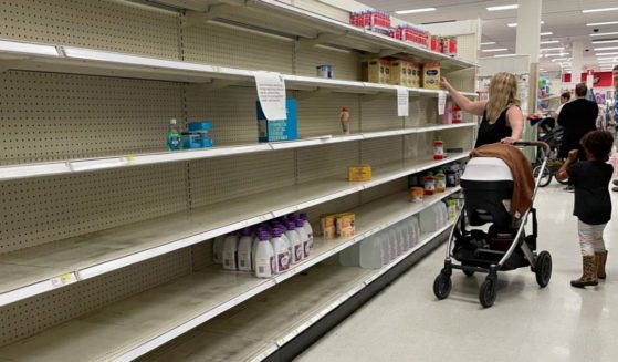 A woman shops for baby formula in front of largely empty shelves at a Target in Annapolis, Maryland, on Monday as a nationwide shortage of baby formula continues.