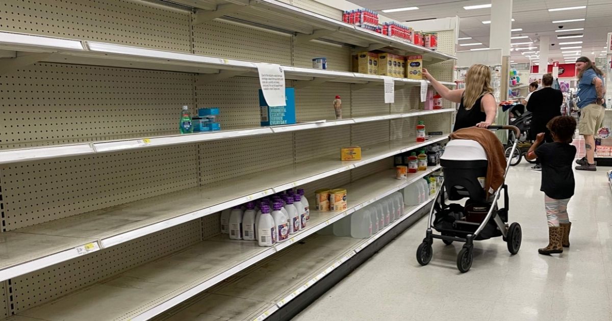A woman shops for baby formula in front of largely empty shelves at a Target in Annapolis, Maryland, on Monday as a nationwide shortage of baby formula continues.
