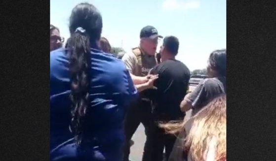 Law enforcement officers restrained parents from entering the school area as the panicked family members begged them to take action during Tuesday's mass shooting in Uvalde, Texas.
