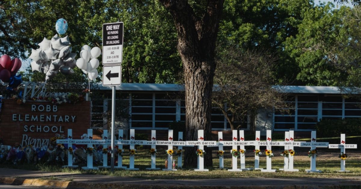 Crosses bearing the names of the victims of a mass shooting are seen in front of Robb Elementary School in Uvalde, Texas. The rural Texas community is in mourning following a shooting at Robb Elementary School which killed 21 people, including 19 children.