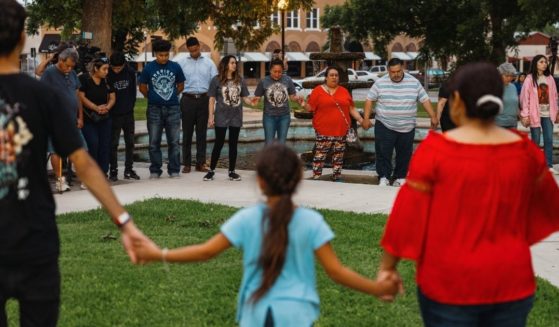 Members of the community gather at the City of Uvalde Town Square for a prayer vigil in the wake of a mass shooting at Robb Elementary School in Uvalde, Texas, on Tuesday.