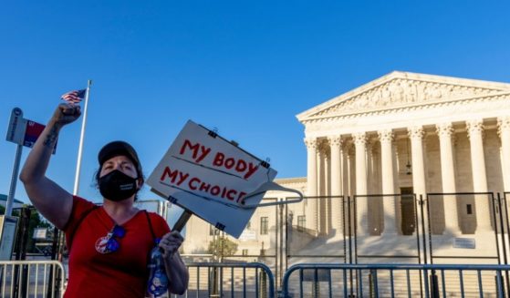 An abortion advocate protests in front of the U.S. Supreme Court on Tuesday in Washington, D.C.