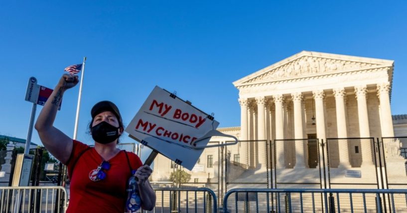 An abortion advocate protests in front of the U.S. Supreme Court on Tuesday in Washington, D.C.