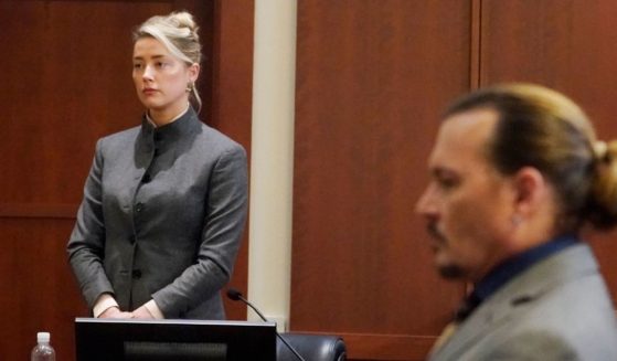 Amber Heard, left, and Johnny Depp, right, watch the jury leave on Monday at the Fairfax County Circuit Courthouse in Fairfax, Virginia.