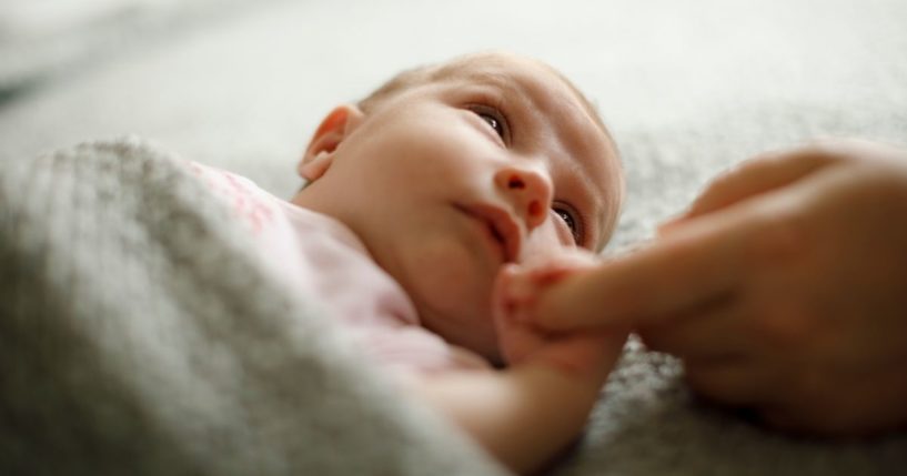 A baby is seen in this stock image.