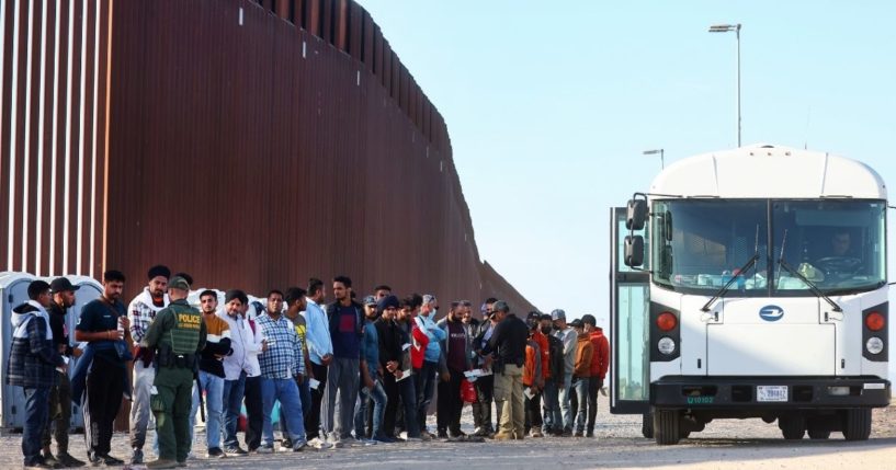 Immigrants wait to board a U.S. Border Patrol bus after illegally crossing the border from Mexico on Thursday in Yuma, Arizona.