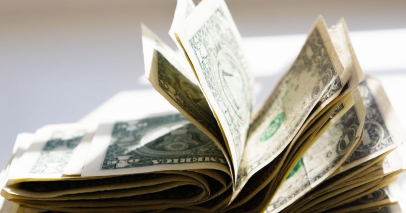 A wad of cash is seen in this stock image.