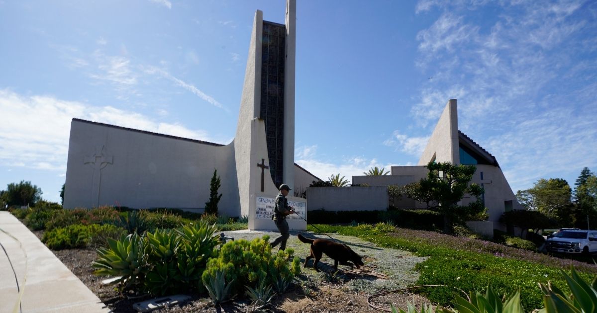 A K-9 unit checks the grounds of Geneva Presbyterian Church in Laguna Woods, California, after a fatal shooting on Sunday.