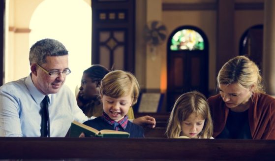 A family sits in a church in the above stock image.