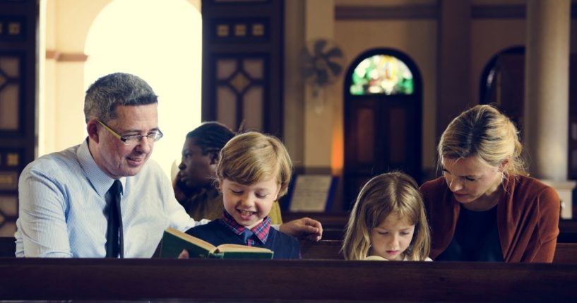 A family sits in a church in the above stock image.