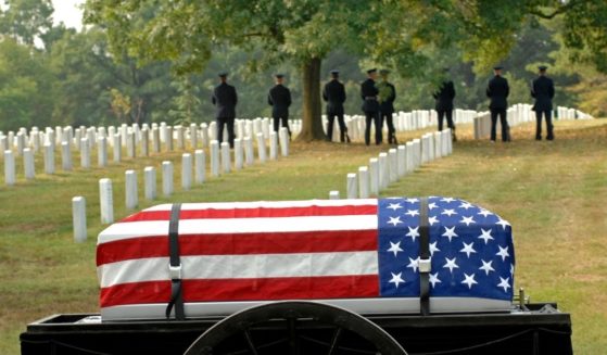 A flag-draped coffin is seen in this stock image.