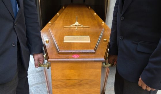 Pallbearers holding a casket.