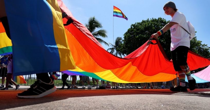 People carry the rainbow flag in the Miami Beach Pride Parade on Sept. 19, 2021, in Miami Beach, Florida.