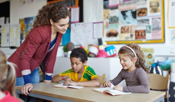 A teacher is seen with her students in this stock image.