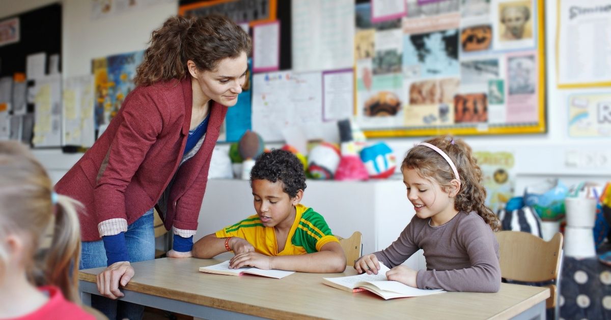 A teacher is seen with her students in this stock image.