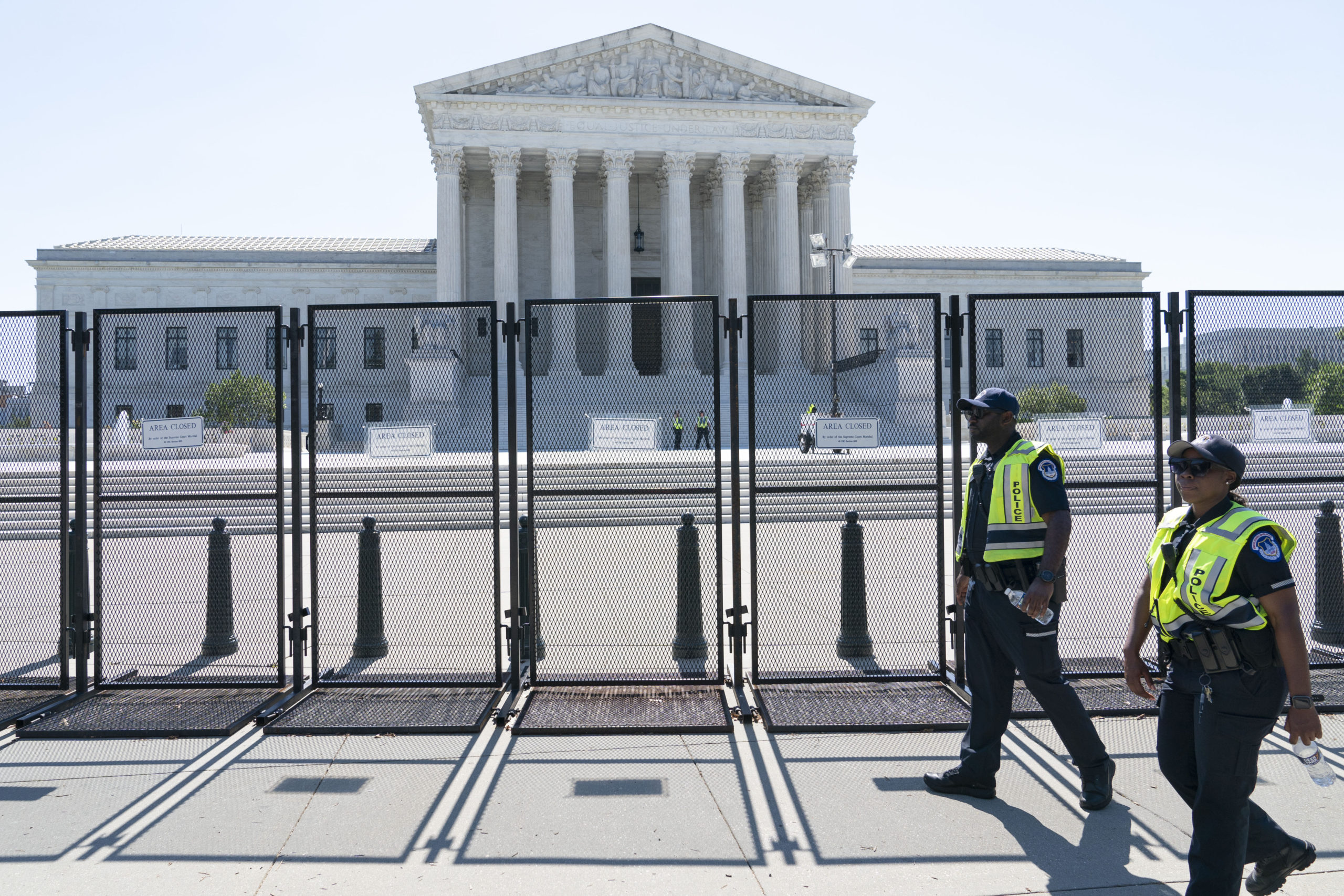 Security officers patrol outside of the Supreme Court, Thursday in Washington.