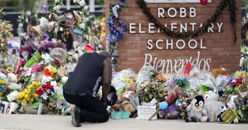 Reggie Daniels pays his respects in front of a memorial at Robb Elementary School in Uvalde, Texas, on Thursday.