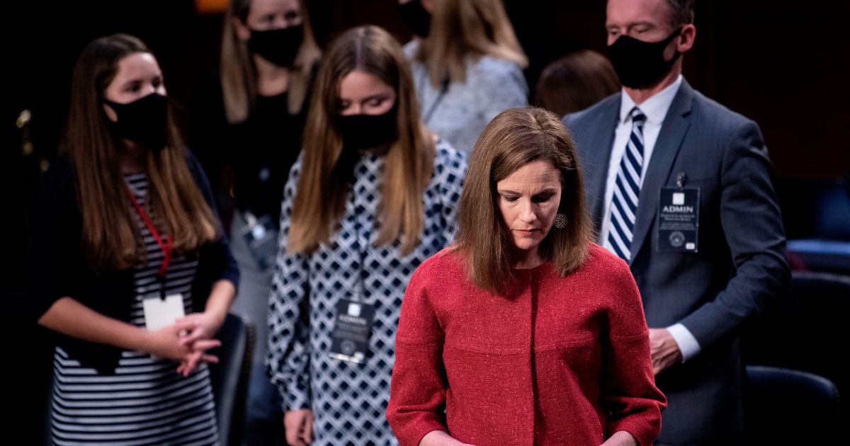 Then-Supreme Court nominee Amy Coney Barrett goes on a break with her family at her confirmation hearing on Capitol Hill in October 2020.