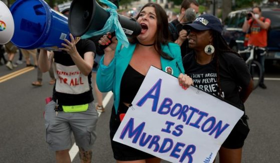 Pro-life and pro-abortion protesters walk to the U.S. Supreme Court on Monday in Washington, D.C.