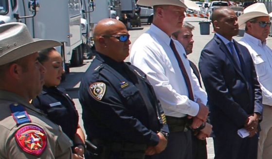 Uvalde School Police Chief Pete Arredondo, third from left, stands outside Robb Elementary school in Uvalde, Texas, at a May 26 news conference.