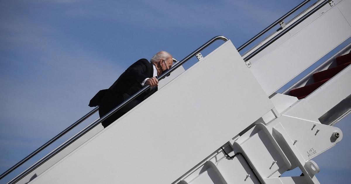 U.S. President Joe Biden trips while boarding Air Force One at Joint Base Andrews, Maryland, on March 19, 2021.