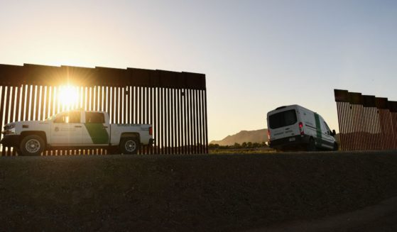 A Border Patrol agent drives a van between a gap along the border wall between the U.S. and Mexico in Yuma, Arizona, on June 1.