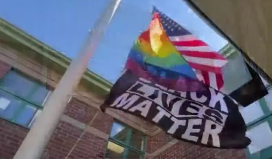 The school has refused to stop flying the gay-pride and Black Lives Matter flags, despite objections from the Catholic diocese.
