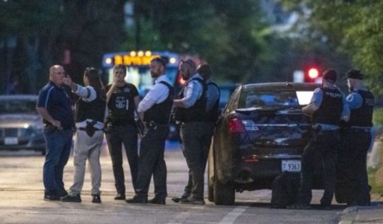Chicago police officers work the scene where an infant was fatally shot on Friday.