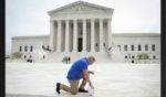 Former Bremerton High School assistant football coach Joe Kennedy takes a knee in front of the U.S. Supreme Court after his legal case, Kennedy vs. Bremerton School District, was argued before the court on April 25 in Washington, DC. Kennedy was terminated from his job by Bremerton public school officials in 2015 after refusing to stop his on-field prayers after football games.