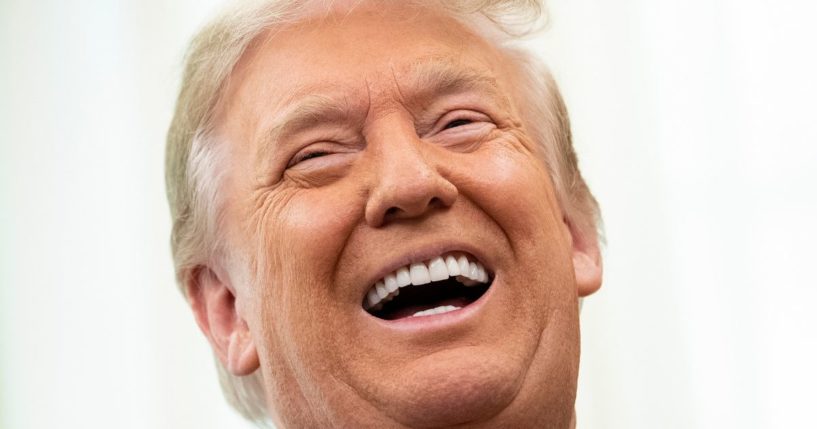 Then-President Donald Trump laughs in the Oval Office of the White House on Dec. 3, 2020, in Washington, D.C.