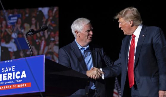 Donald Trump welcomes Mo Brooks to the stage during a "Save America" rally