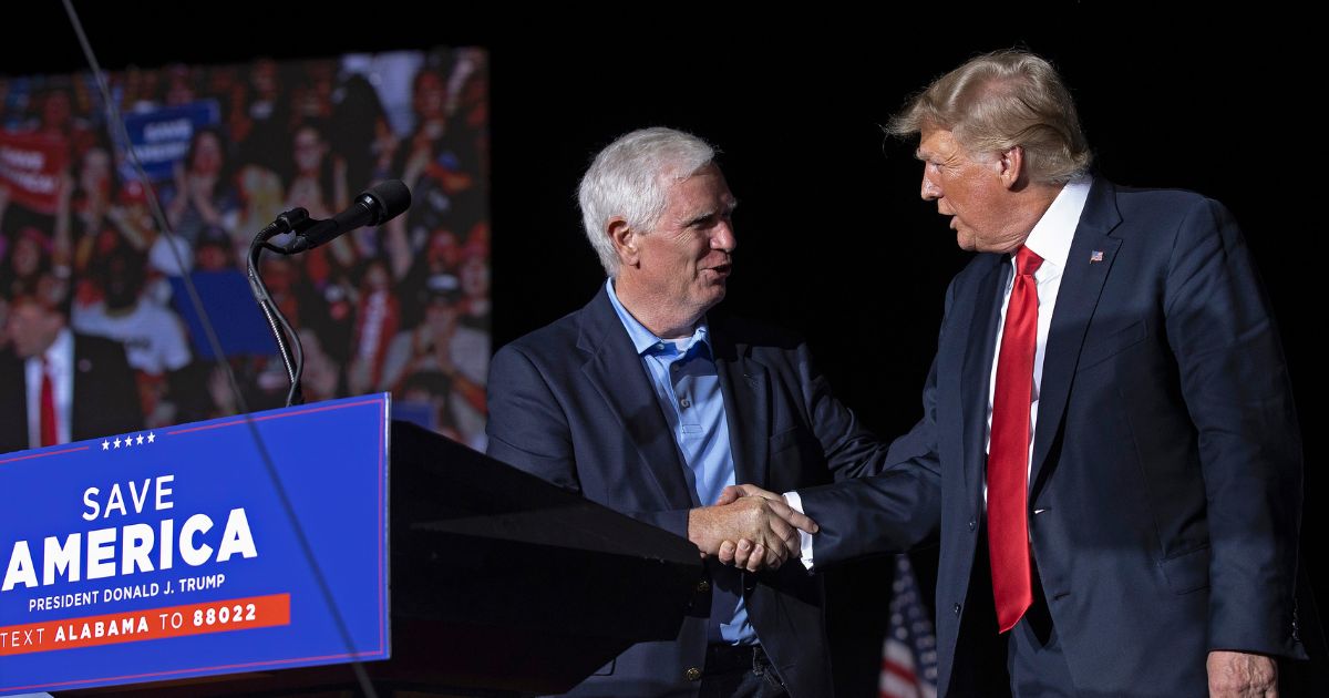 Donald Trump welcomes Mo Brooks to the stage during a "Save America" rally