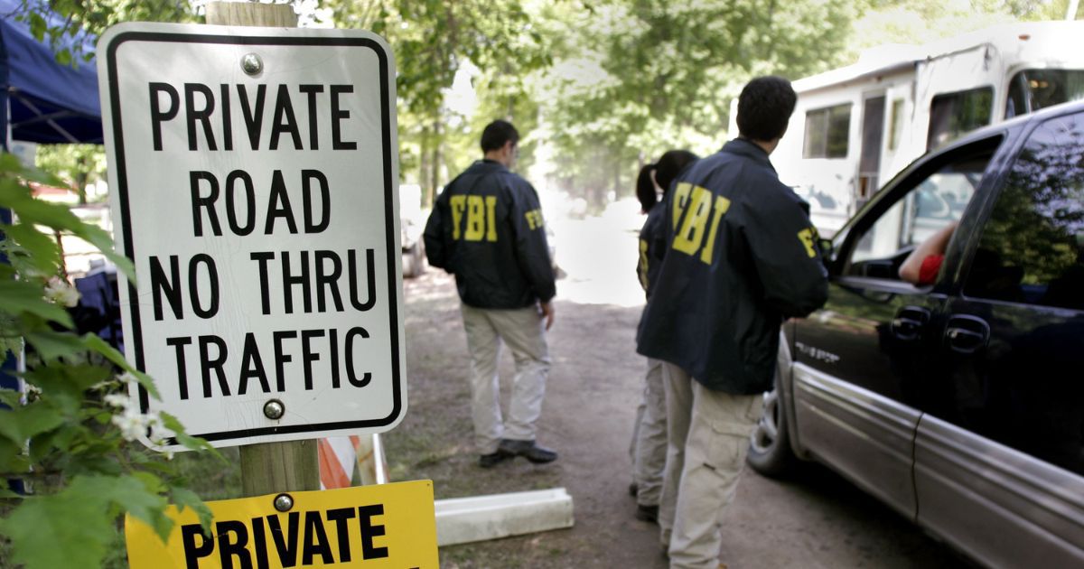 FBI agents stand at a check point at the Hidden Dreams Horse Farm on May 24, 2006 in Milford, Michigan.