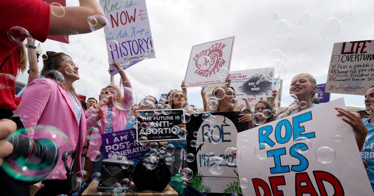 Pro-life activists celebrate outside the Supreme Court on Friday in Washington, D.C.