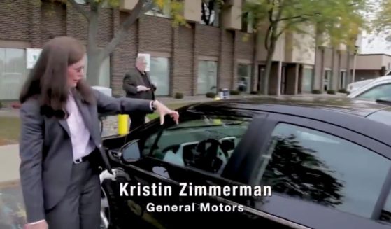 GM spokeswoman Kristin Zimmerman shows off the company's new electric car in 2021.