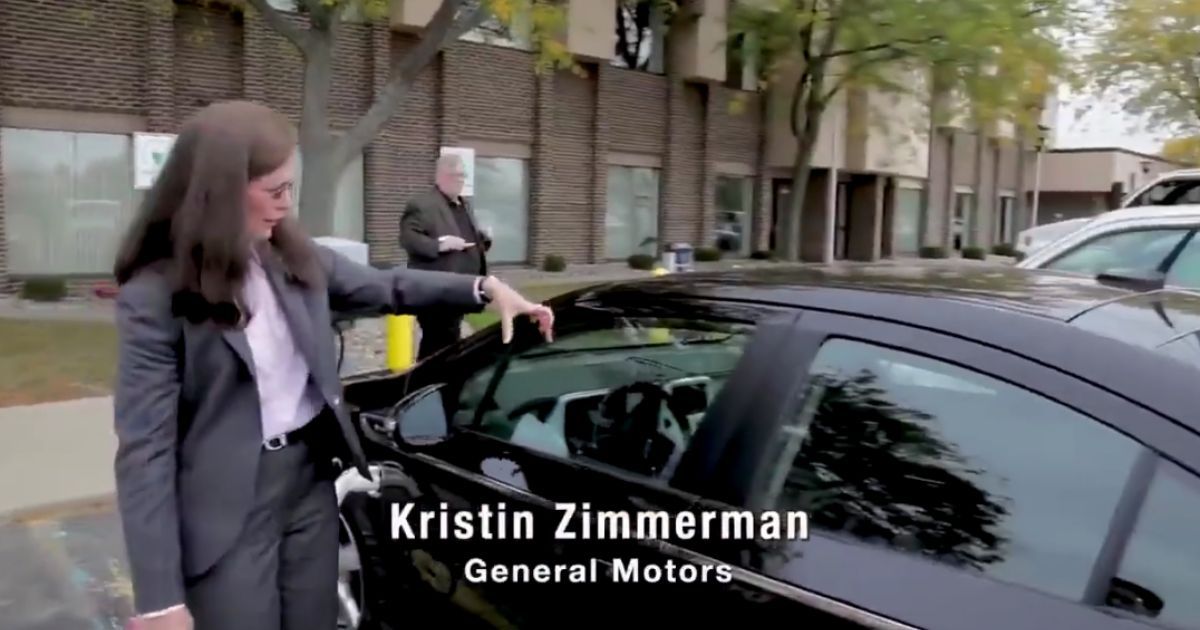 GM spokeswoman Kristin Zimmerman shows off the company's new electric car in 2021.