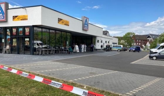 Police work the scene of a shooting at an Aldi in the small town of Treysa, Germany.