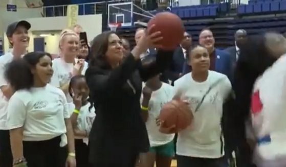 Kamala Harris takes a shot with a basketball at American University on Wednesday.