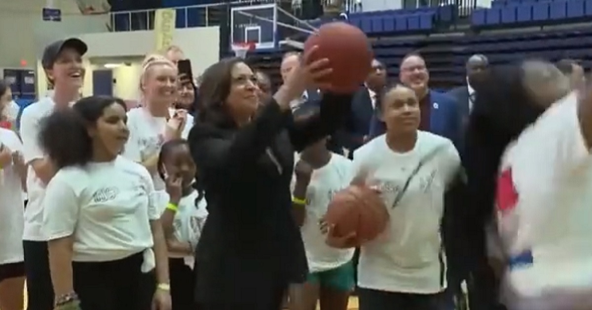 Kamala Harris takes a shot with a basketball at American University on Wednesday.