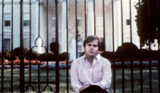 John Hinckley, who attempted to assassinate then-President Ronald Reagan on March 30, 1981, sits outside the White House.