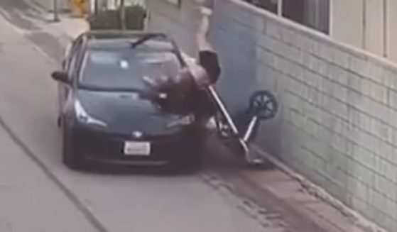 When she saw the driver swerve toward her, the mother lifted the stroller to try to protect her child before the car hit them.