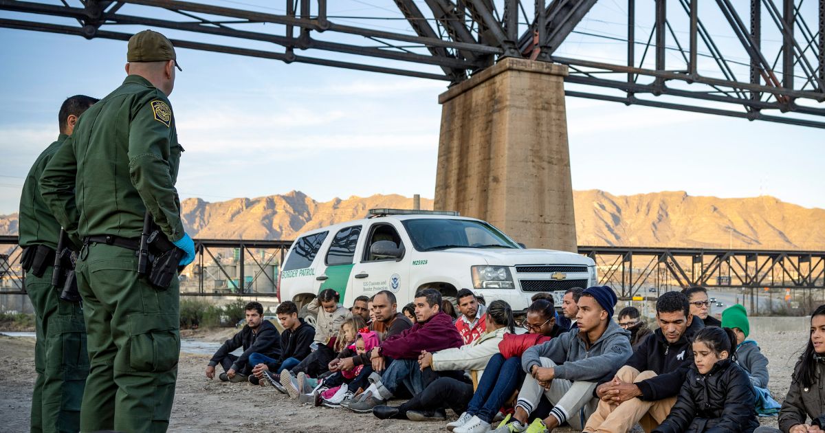 A group of about 30 immigrants that illegally crossed the border from Mexico into the U.S. are detained by U.S. Border Patrol agents.