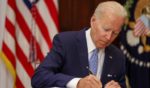 President Joe Biden signs the Bipartisan Safer Communities Act into law in the Roosevelt Room of the White House in Washington, D.C., on Saturday.
