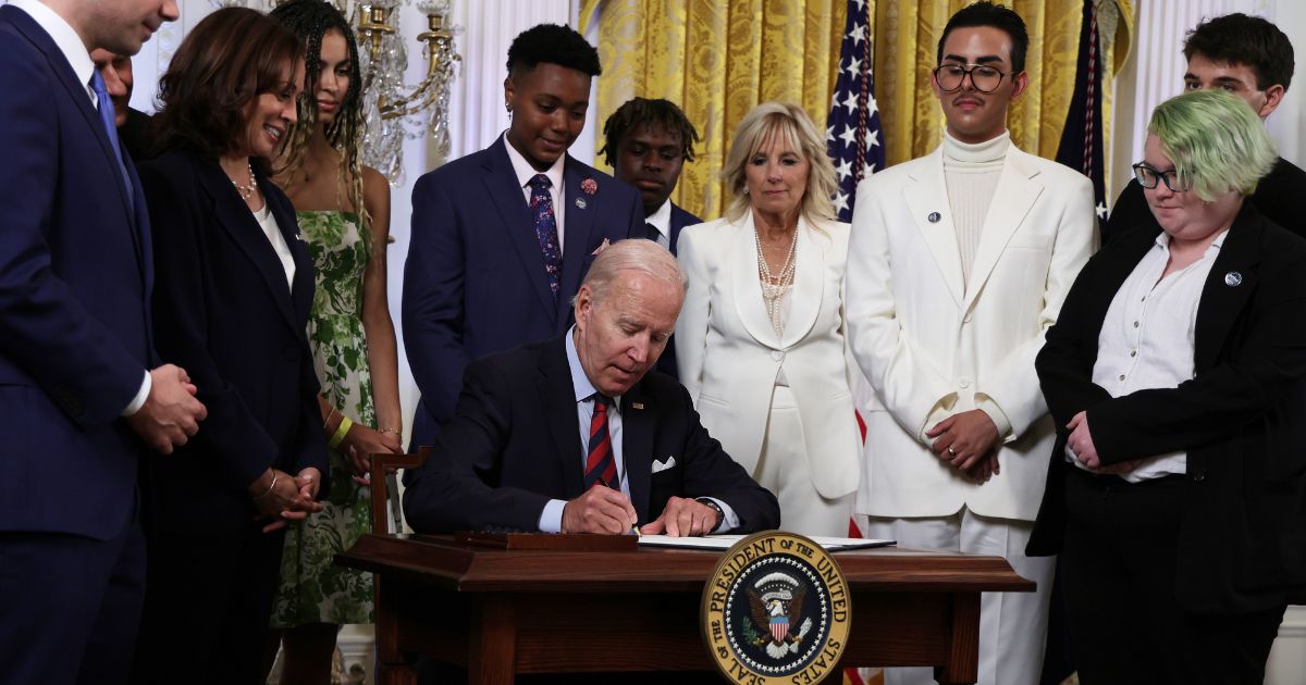 President Joe Biden signs an executive order in the East Room of the White House on Wednesday in Washington, D.C.