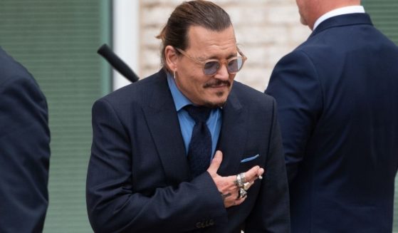 Actor Johnny Depp bows to his fans during a recess outside court in Fairfax, Virginia, Friday. A jury awarded Depp $15 million in his defamation case against ex-wife Amber Heard, but the jury also awarded $2 million to Heard in her countersuit against Depp.