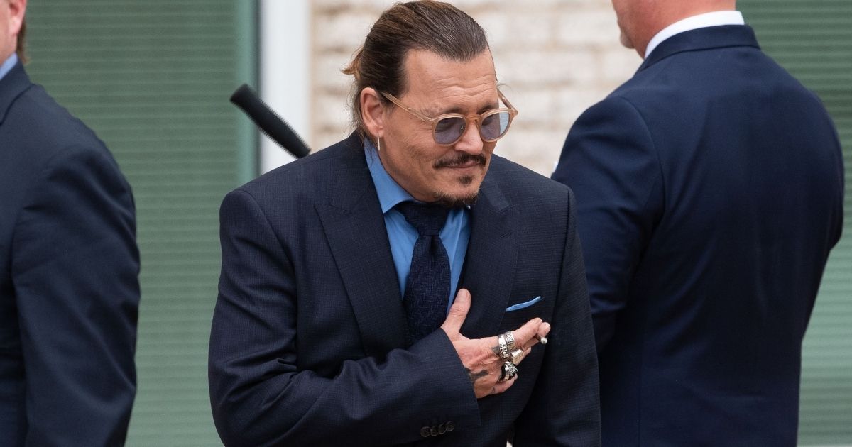 Actor Johnny Depp bows to his fans during a recess outside court in Fairfax, Virginia, Friday. A jury awarded Depp $15 million in his defamation case against ex-wife Amber Heard, but the jury also awarded $2 million to Heard in her countersuit against Depp.