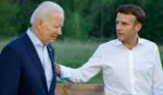 President Joe Biden, left, and French President Emmanuel Macron, right, talk after taking a group photo during the G7 Summit at Elmau Castle in Germany on Sunday.